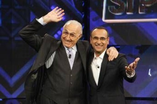 Baudo, Conti ricorda il grande conduttore: "Lui è la tv, indimenticabili i suoi abbracci paterni" Baudo, Conti ricorda il grande conduttore: "Lui è la tv, indimenticabili i suoi abbracci paterni"